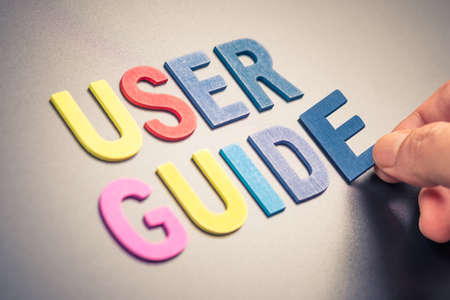 Hand place a wood alphabets as word USER GUIDEの写真素材