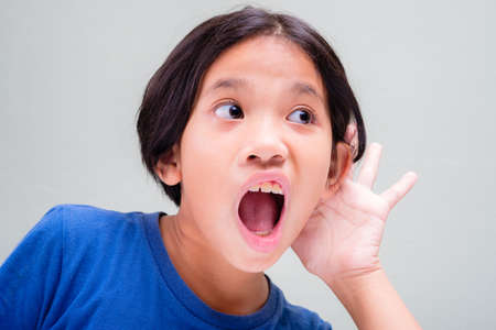 Nine years old girl cup her ear to hear better, unbelievable gossip story