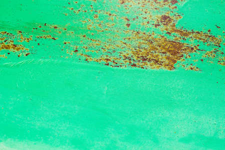 Abstract background of metal painted in green color with some rust, metal textureの写真素材