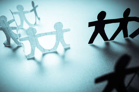 Black paper human chain going to connect with the white team, two different chain doll teams can be join togetherの写真素材