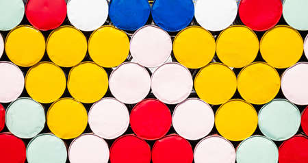 Colorful fuel tanks painted in vibrant color, stack of petrol containers at train station