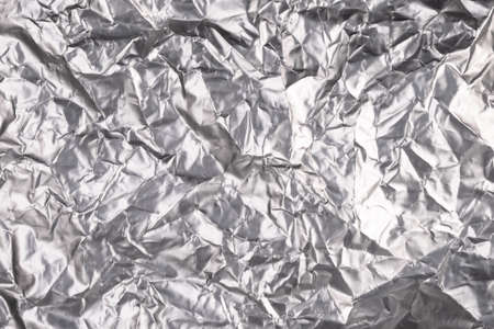 Silver aluminium foil in crumpled condition, foil paper for wrap the food as texture resourceの写真素材