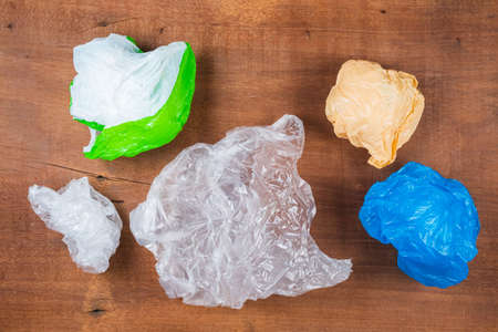 Trash plastic bags on wood board, reuse and reduce plastic concept