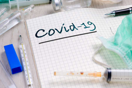 Covid-19 text on notebook with medical equipment, knowledge for coronavirus or covid-19 pandemic...