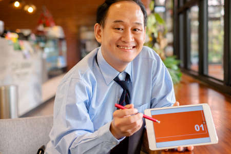 Thai insurance agent offer insurance case product from computer tablet