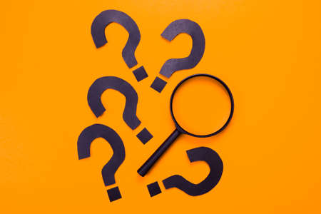 Magnifying glass with many qustion mark symbol on yellow backgroundの写真素材