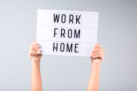 Hands show alphabet sign with text WORK FROM HOMEの写真素材