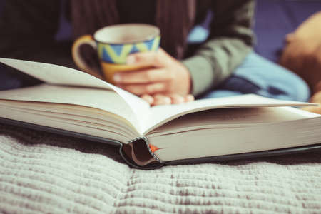 Close up child reading the book at home