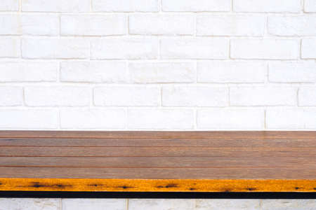 Abstract wood table bar or wood shelf close at the white brick wall