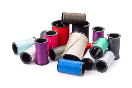 Group of colorful thread spools isolated on white background