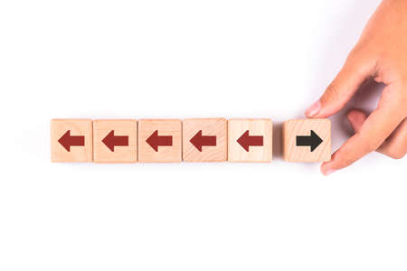 Hand pick a wooden cube that has a different direction from the others