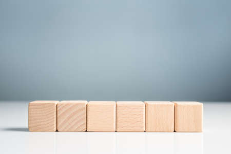 Wood blocks in a row on green wall background, element for insert icon or text with copy spaceの写真素材
