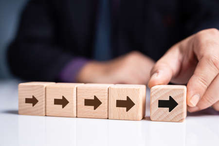 Businessman move the leader wood cube with many follower behind, leadership or influencer marketing conceptの写真素材