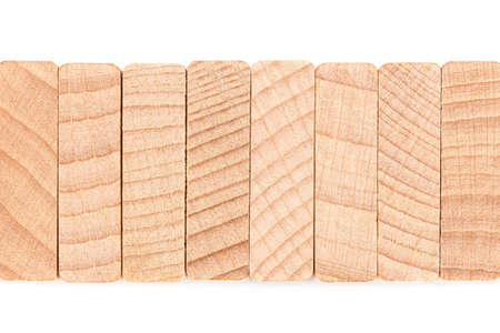 Closeup detail of cut wood pieces (top side of wood domino)  arranged in stack row, wood texture and...