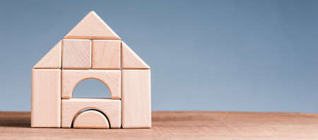 Wooden blocks toy built as a house on the tableの写真素材