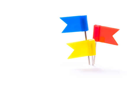 Different color flag push pins prick together at one point, isolated on white backgroundの写真素材