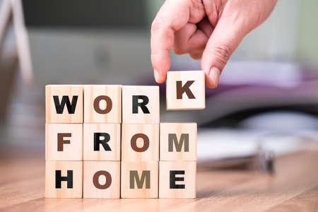 Hand arrange the alphabet wood cubes on the desk, Work From Home concept