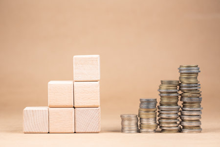 Heap coins stairs growing as arranged wood cubes on the left, plan and result conceptの写真素材
