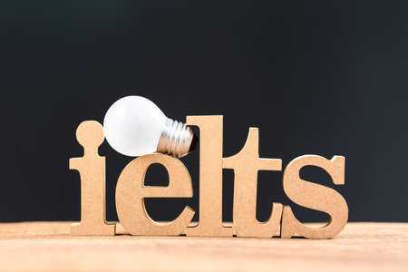 Ielts wood word with liight bulb, acronym of International English Language Testing System concept