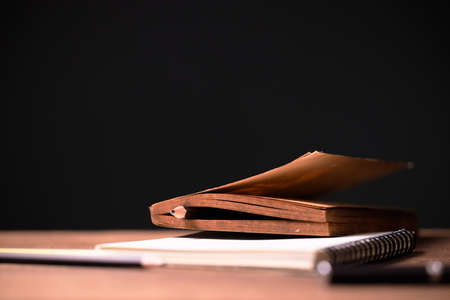 Closeup old book that has the yellowed paper with a pencil as a bookmark of the interesting content,...