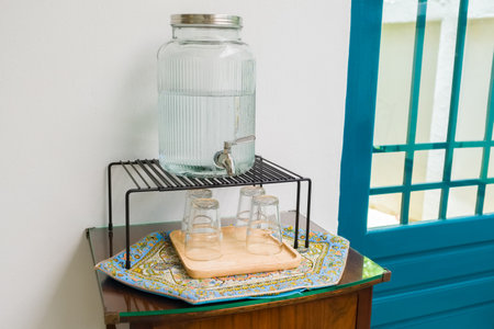 A drinking water jar with tap at the self-service for customers in the cafe