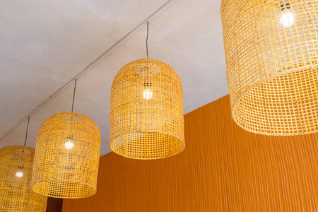 Designed ceiling lamps made of weaved bamboo sticks, adapted from Thai traditional fishing coopの写真素材