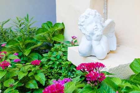 Child cupid statue decorated in the garden corner at homeの写真素材