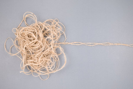 The tangled rope concept with trace lines as the root of the problem, or solution, unravels the confused rope, mental problem, or difficult situation that is hard to resolveの写真素材