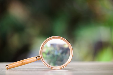 A magnifying glass on green backgroundの写真素材