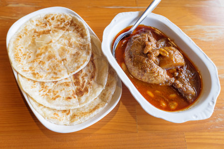 Spicy Muslim chicken curry, or Massaman, combination food with Indian chapati, or Roti, traditional food in Thai restaurantの写真素材