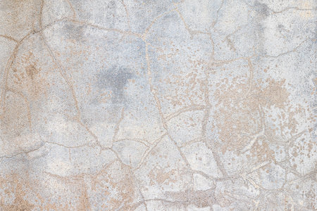 Old concrete wall with many cracked lines and cement stainの写真素材