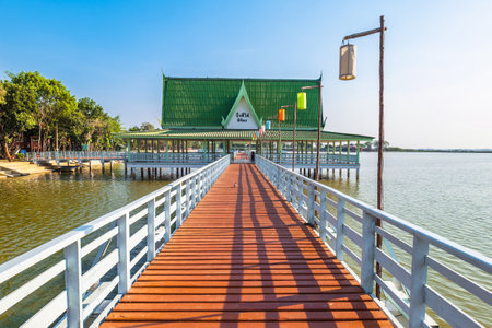 Wood dock and pavilion on the bank of a famous swamp named Bueng Si Fai, a tourist attraction in Phichit province, Thailandの写真素材