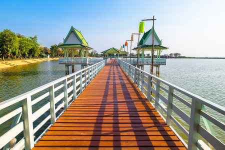 Wood dock and pavilion on the bank of a famous swamp named Bueng Si Fai, a tourist attraction in Phichit province, Thailandの写真素材