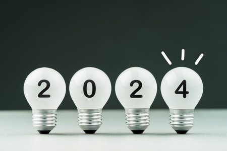 Light bulbs in a row with 2024 numbers and drawing gritter, new idea, new plan for 2024 coming yearの写真素材