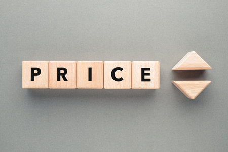 Price text by alphabet wood cubes with up and down symbol, price reguation, marketing, and economic conceptの写真素材