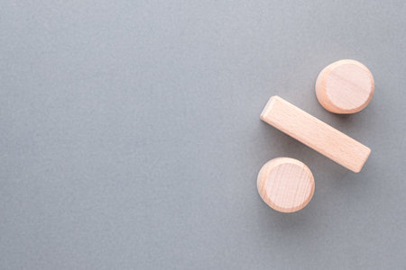 Percent icon sign arranged by wooden toy on gray background with empty spaceの写真素材