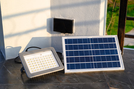 Solar panel with single LED light lamp on the rooftop, a combination of a power source and lighting ...