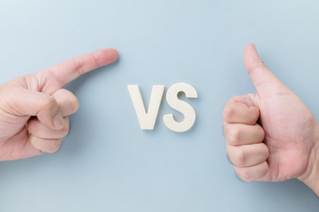 Symbolic hands of two different kinds of boss, controlling, domineering employee versus admiring, or compliment, boss and leader, or teaching the child conceptの写真素材