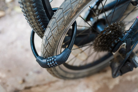 Closeup bike cable lock with four digit code at the rear wheels of the two bicyclesの写真素材