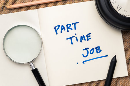 Part-Time Job handwriting text as note in the notepad, with magnifying glass, top view on the deskの写真素材