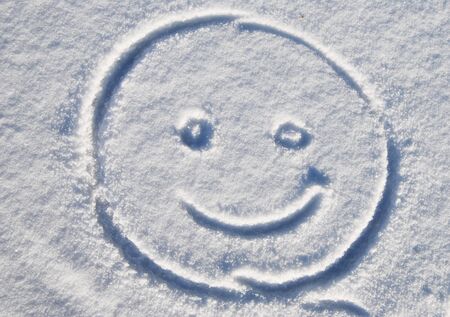 smiles drawing on the fresh snowの写真素材