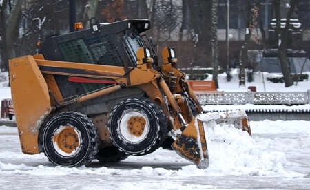 Excavator clears snow on the streets of Kiev Ukraine
