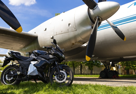 Ukraine, Kiev April -27 2018:Sport bike on the background of an old airplane.Kiev April-27 2018のeditorial素材