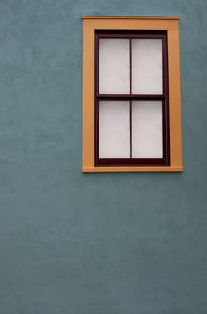 Adobe wall and colorful window