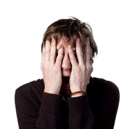 Scared man hiding behnid his hands