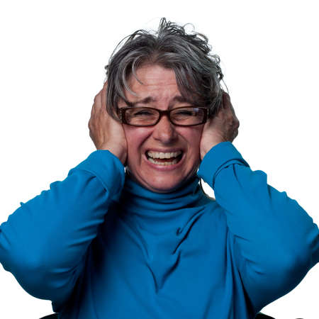 Lady covers her ears when a loud noise his heardの写真素材