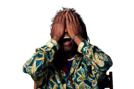 Man covers his face in disbelief, isolated imageの写真素材