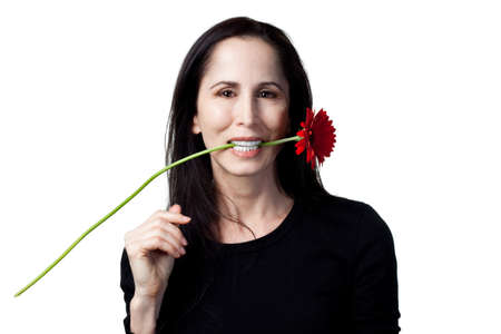 Woman holding a red daisy, isolated studio imageの写真素材