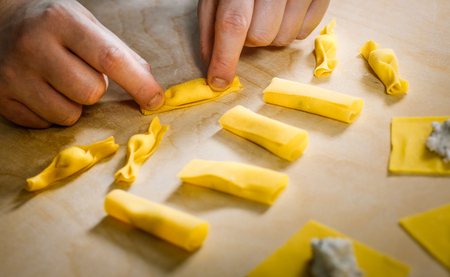 Preparing hand made fresh stuffed pasta shaped like a candyの写真素材