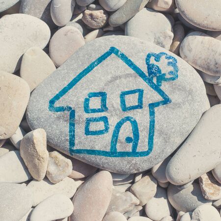 A house childlike drawn on a stoneの写真素材